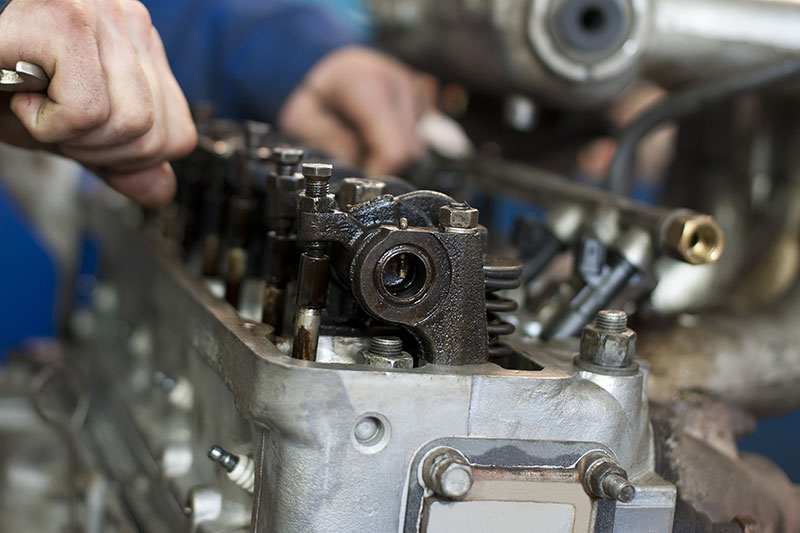 mechanic working on car engine
